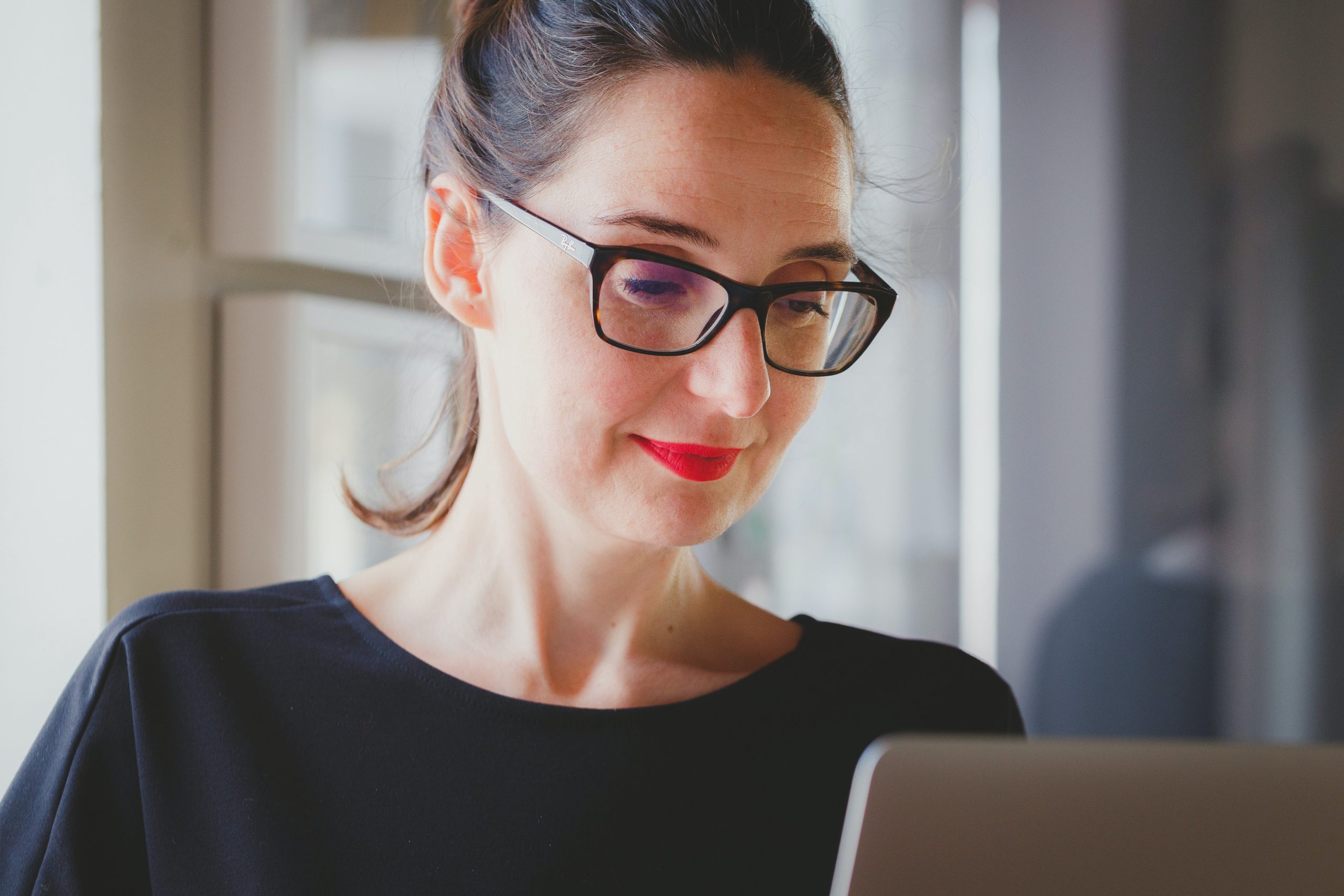 woman smiling at a laptop