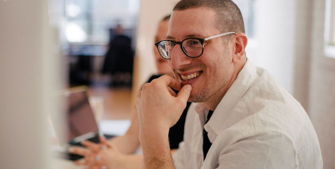 landscape image of a man laughing in a meeting