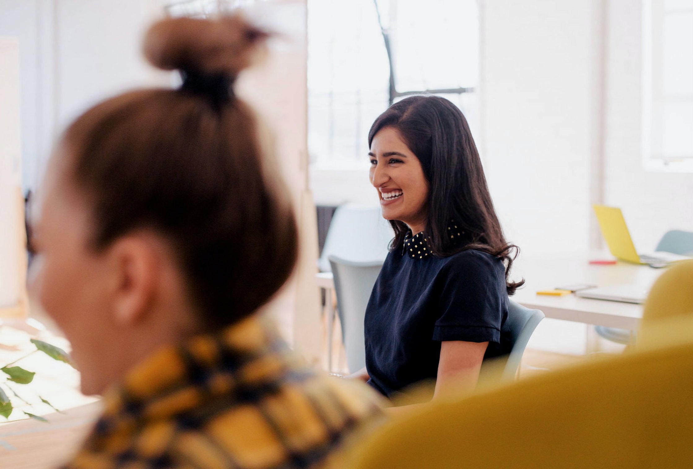 two women talking in a meeting