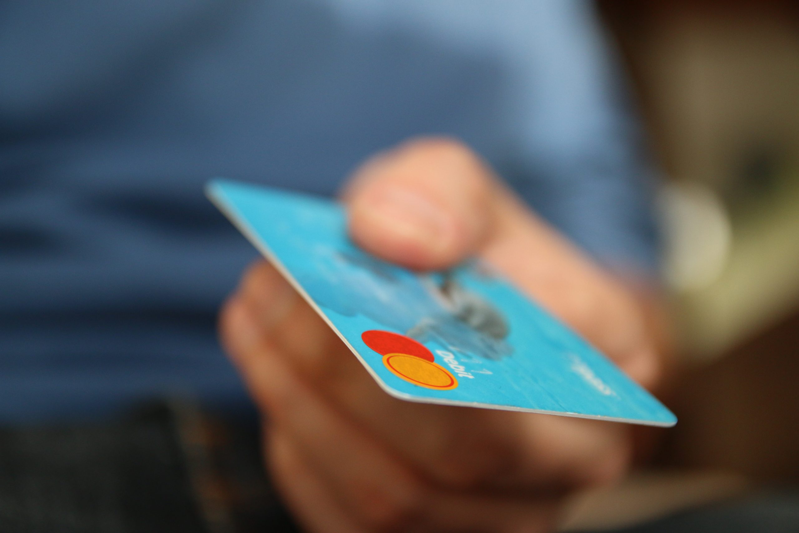 person holding a debit card