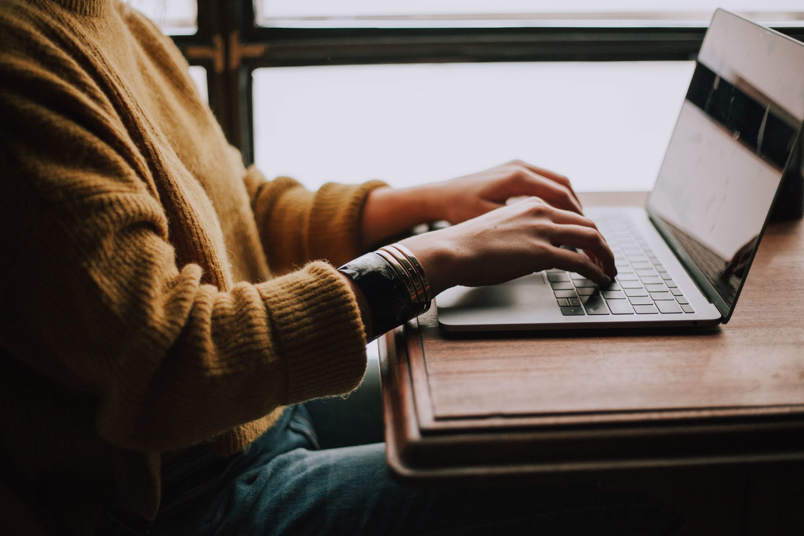 Man Typing On A Laptop