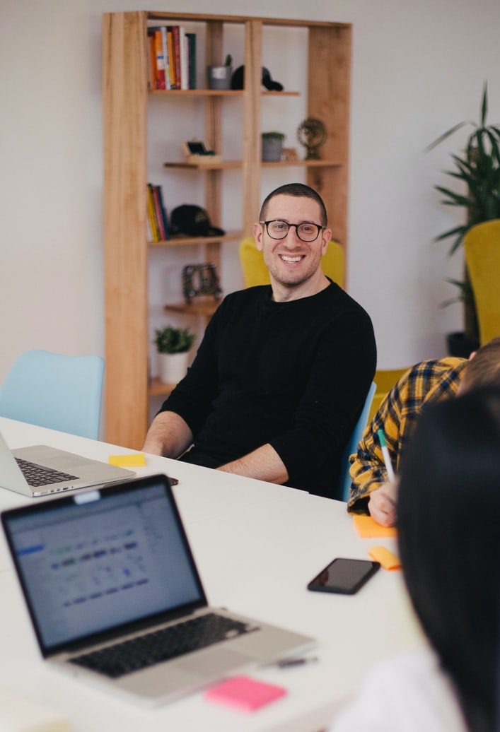 people speaking around a meeting table