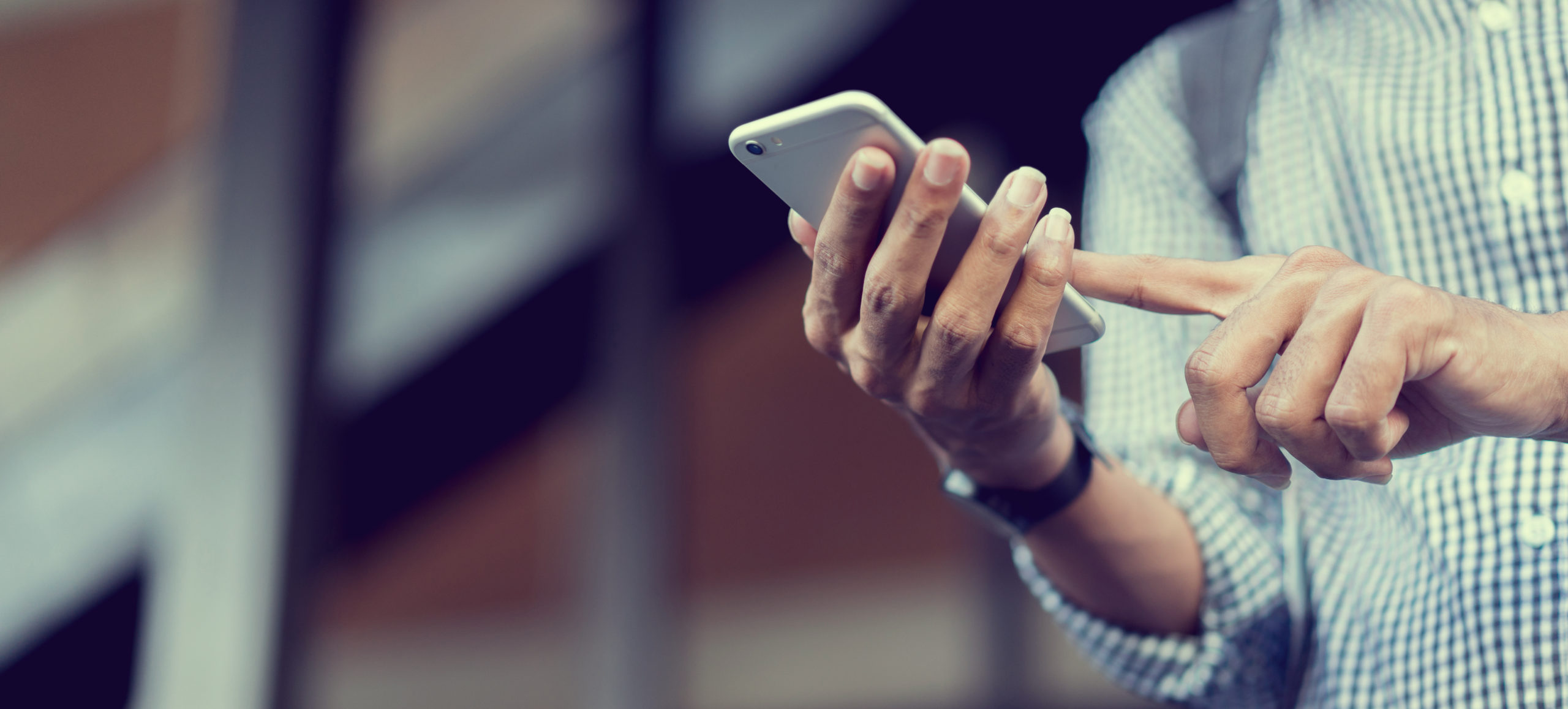 Man with long fingernails holding mobile