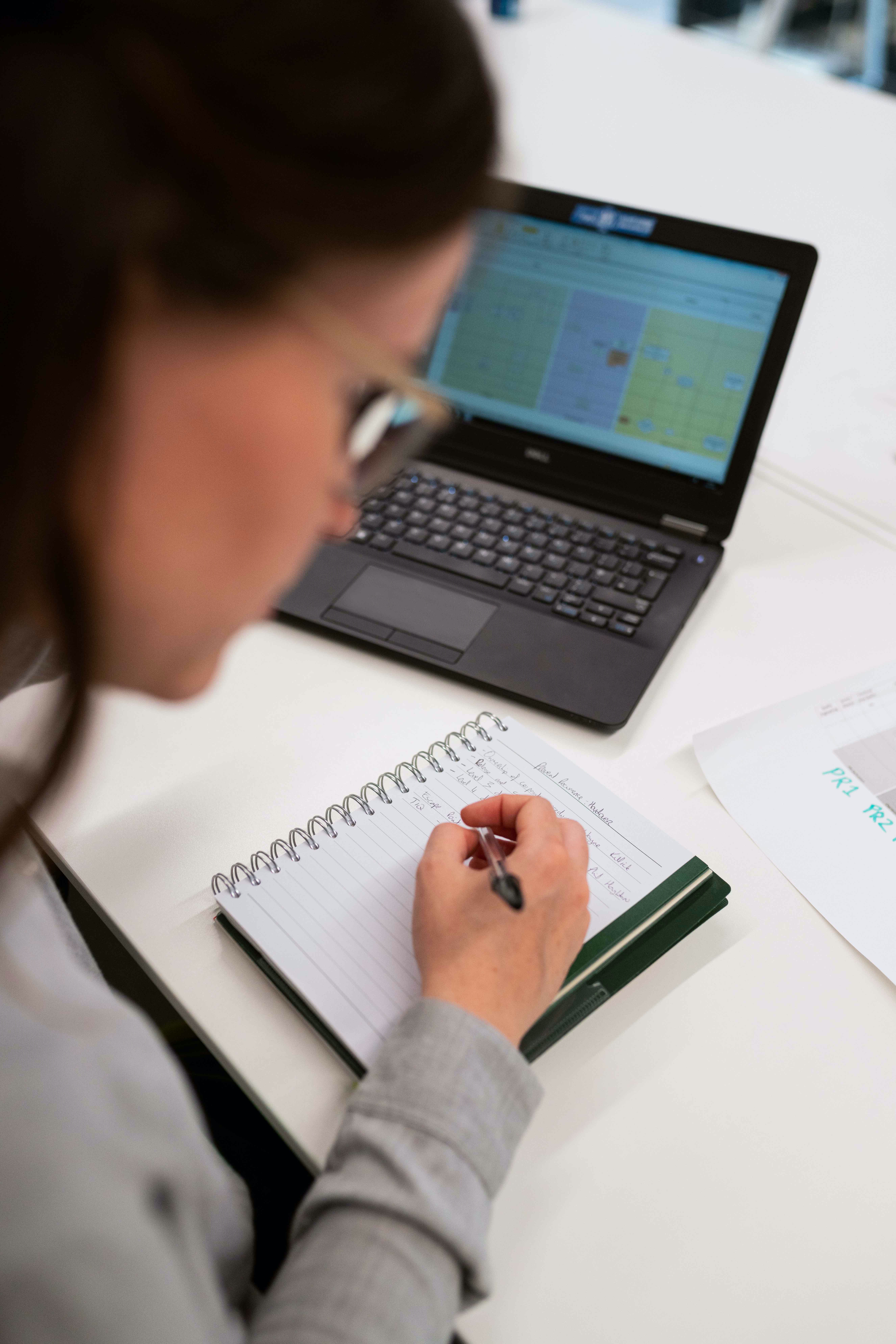 woman writing in note book