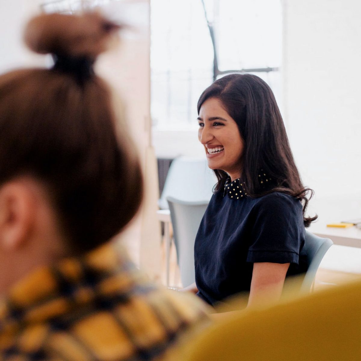 two women talking in a meeting