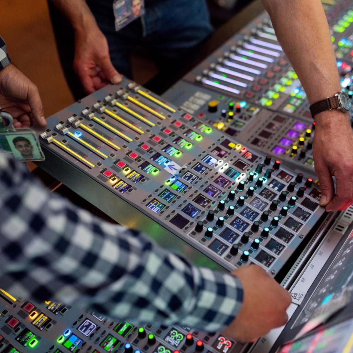 men working on a sound board