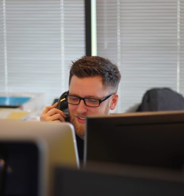 Man Wearing Glasses Talking On The Phone